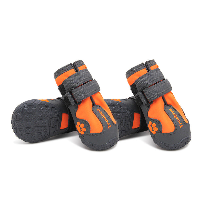 Orange and gray pet boots with paw design on a white background
