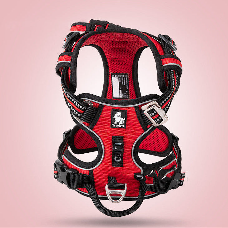Red dog harness with black straps on a pink background