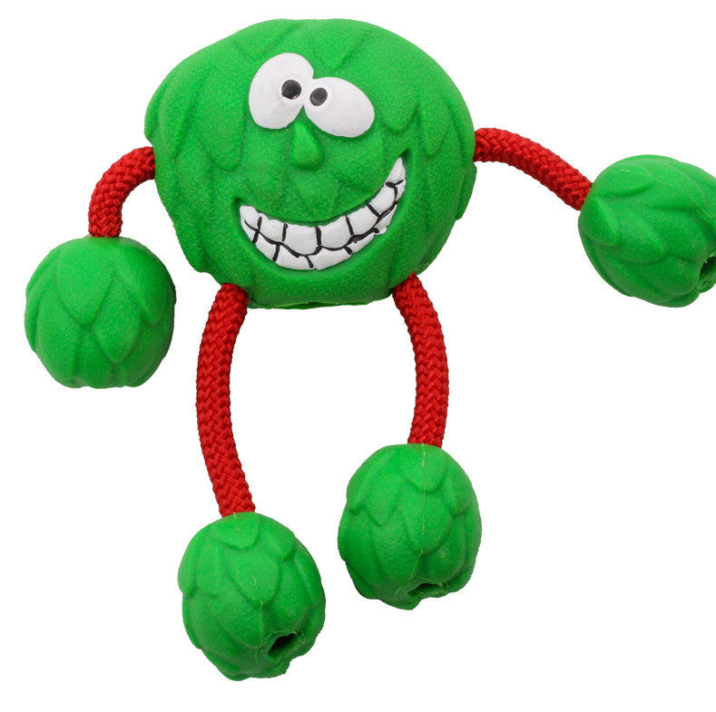 Green dog toy with a smiling face and red arms on a white background