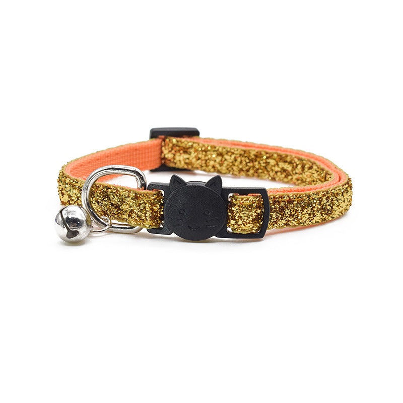 Gold glitter cat collar with black bell and cat-shaped tag on a white background
