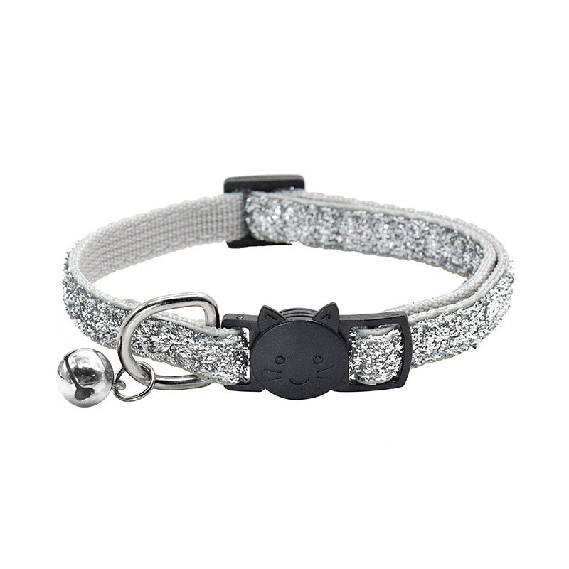 Cat collar with glittery strap, bell, and black cat face design on a white background