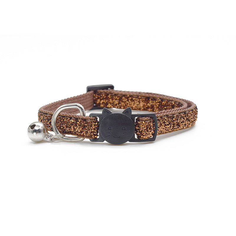 Cat collar with glittery brown strap, black buckle, and silver bell on a white background
