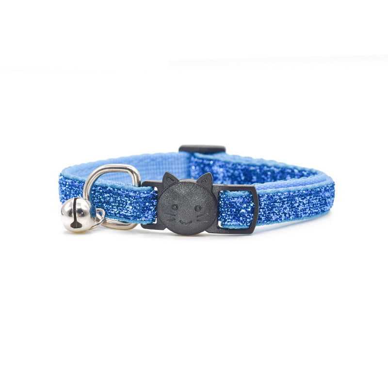 Blue glittery cat collar with bell and black cat-shaped tag on a white background