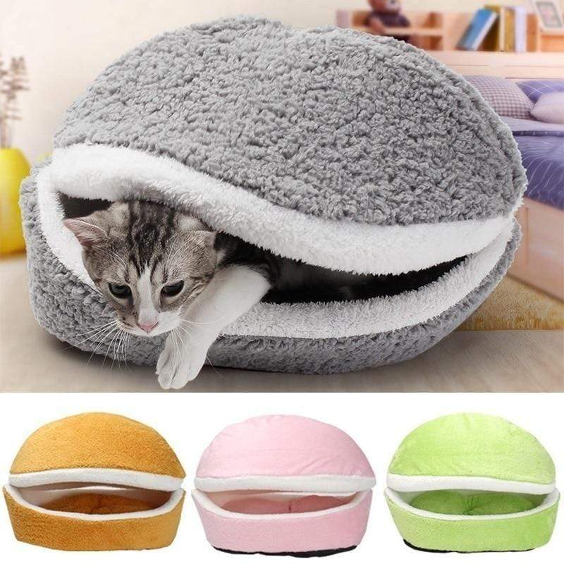 Cat lying inside a gray pet bed shaped like a hamburger, with additional color options displayed below.