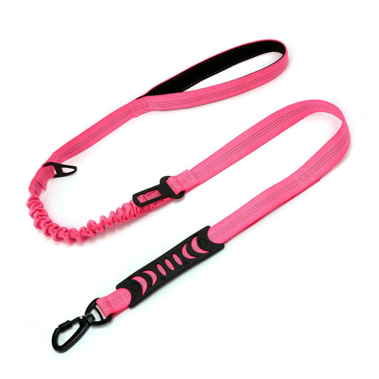 Pink dog leash with black handle and clip on a white background