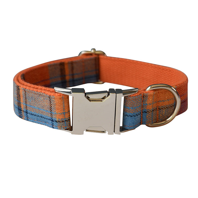Dog collar with orange and blue plaid pattern on a white background