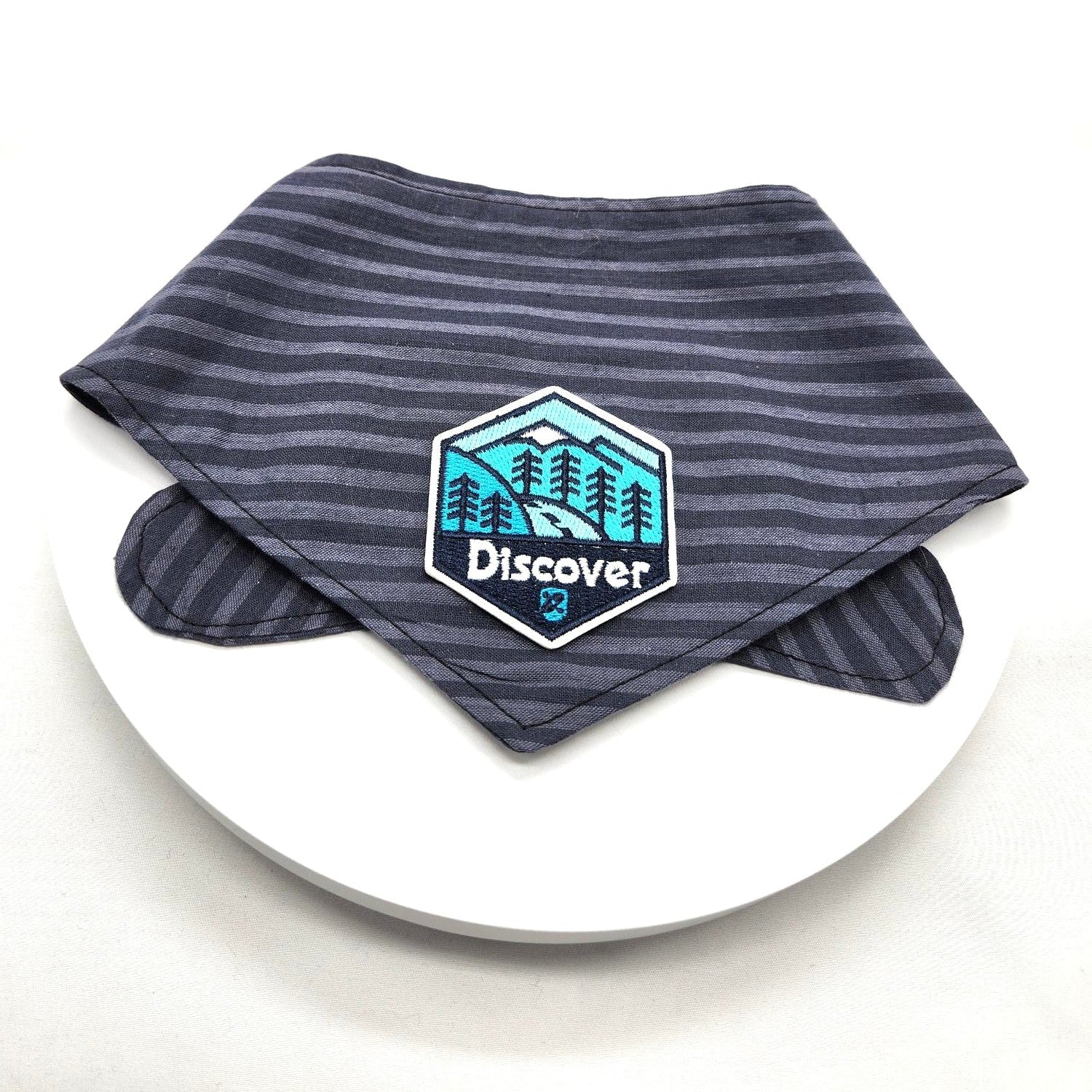 Blue striped bandana with a logo on a white plate