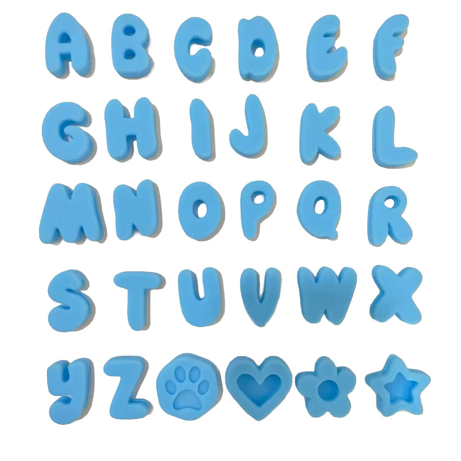 Blue alphabet letter set with decorative shapes including a paw print, heart, flower, and star, arranged on a plain white background.