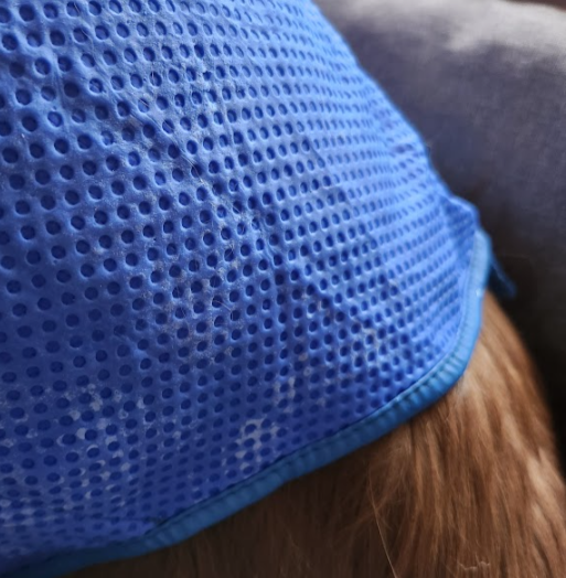 Close-up of a blue mesh fabric with a textured pattern.