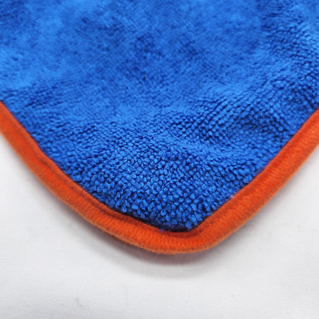 Blue microfiber cloth with orange border on a white background