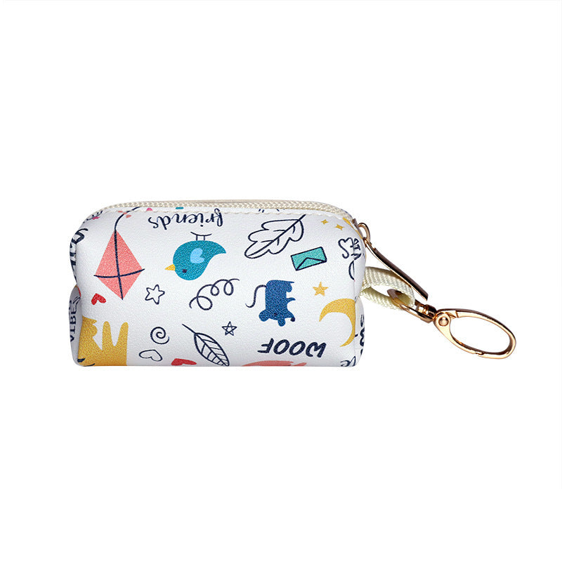 Small poop bag dispenser pouch with colorful patterns and a gold zipper on a white background
