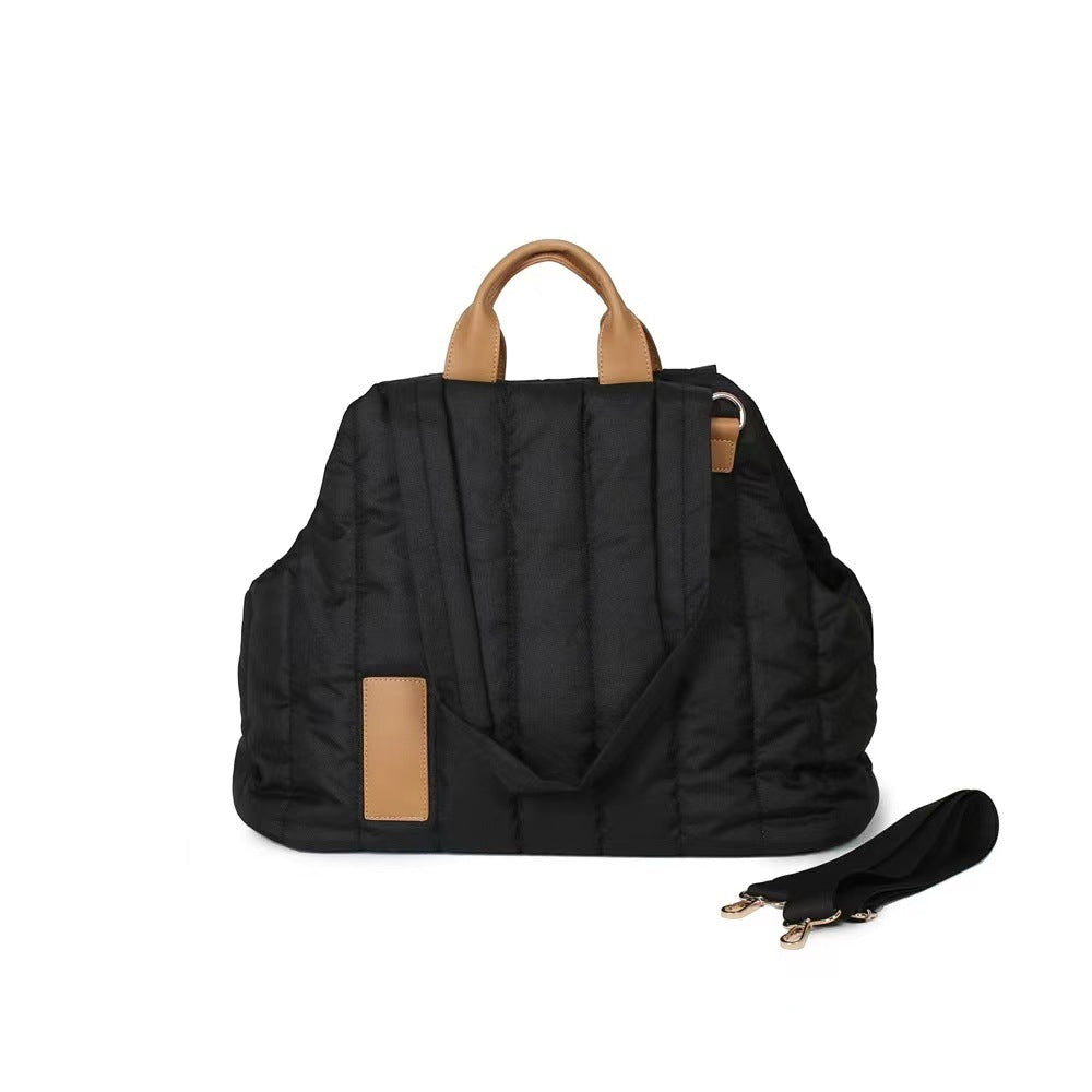 Black backpack with brown leather straps on a white background