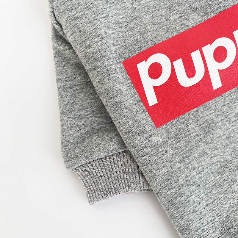 Gray dog sweatshirt with a red and white logo on a light gray background