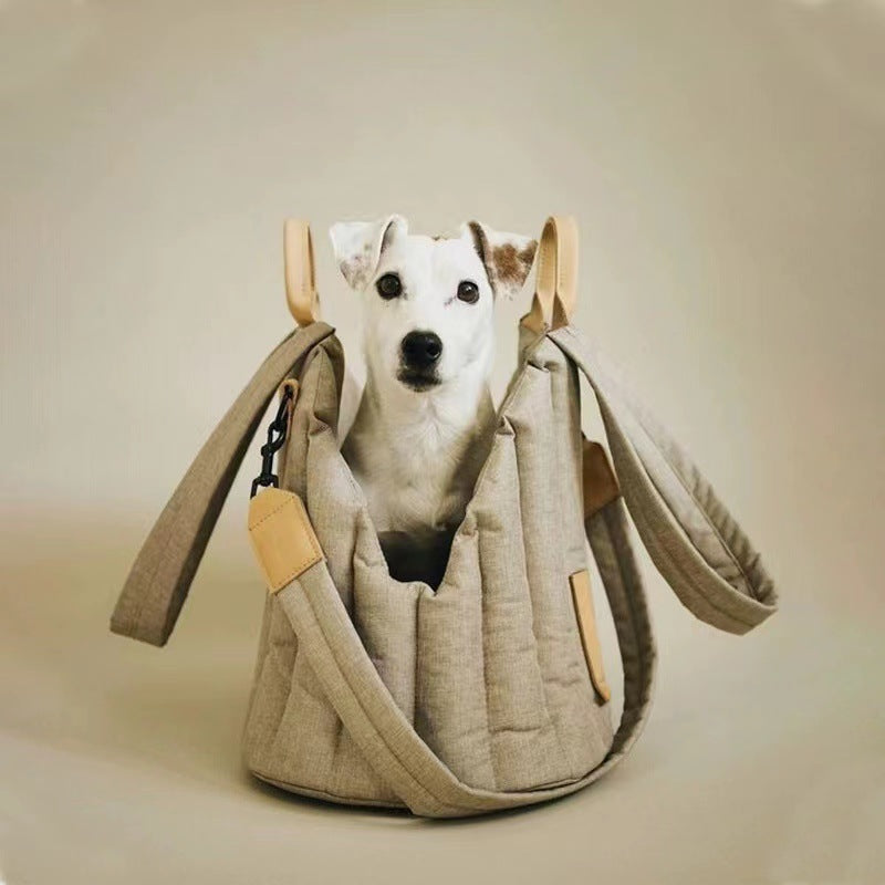 Dog inside a beige pet carrier with a neutral background