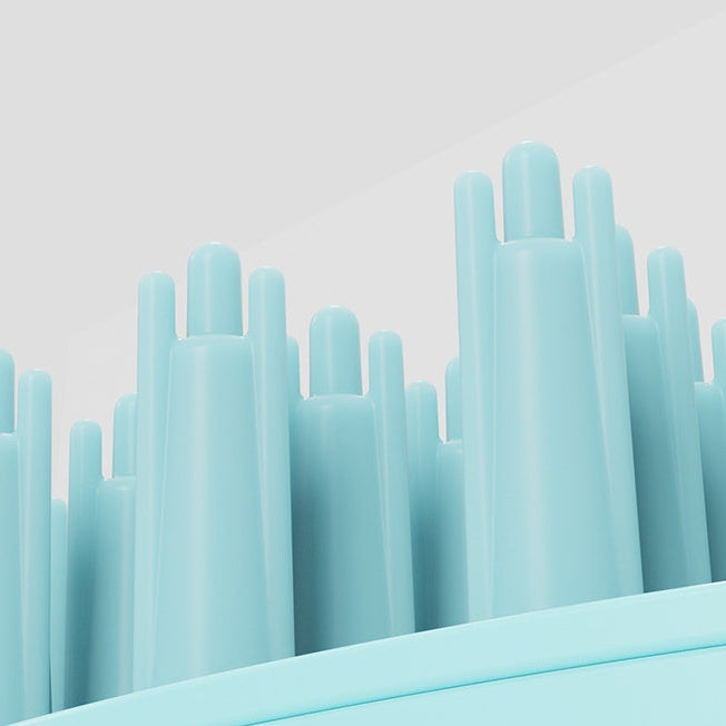 Stack of light blue silicone straws from a pet bath brush on a light gray background