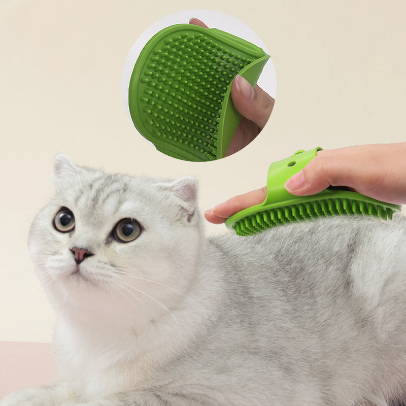 Green cat grooming brush being used on a gray cat with a beige background