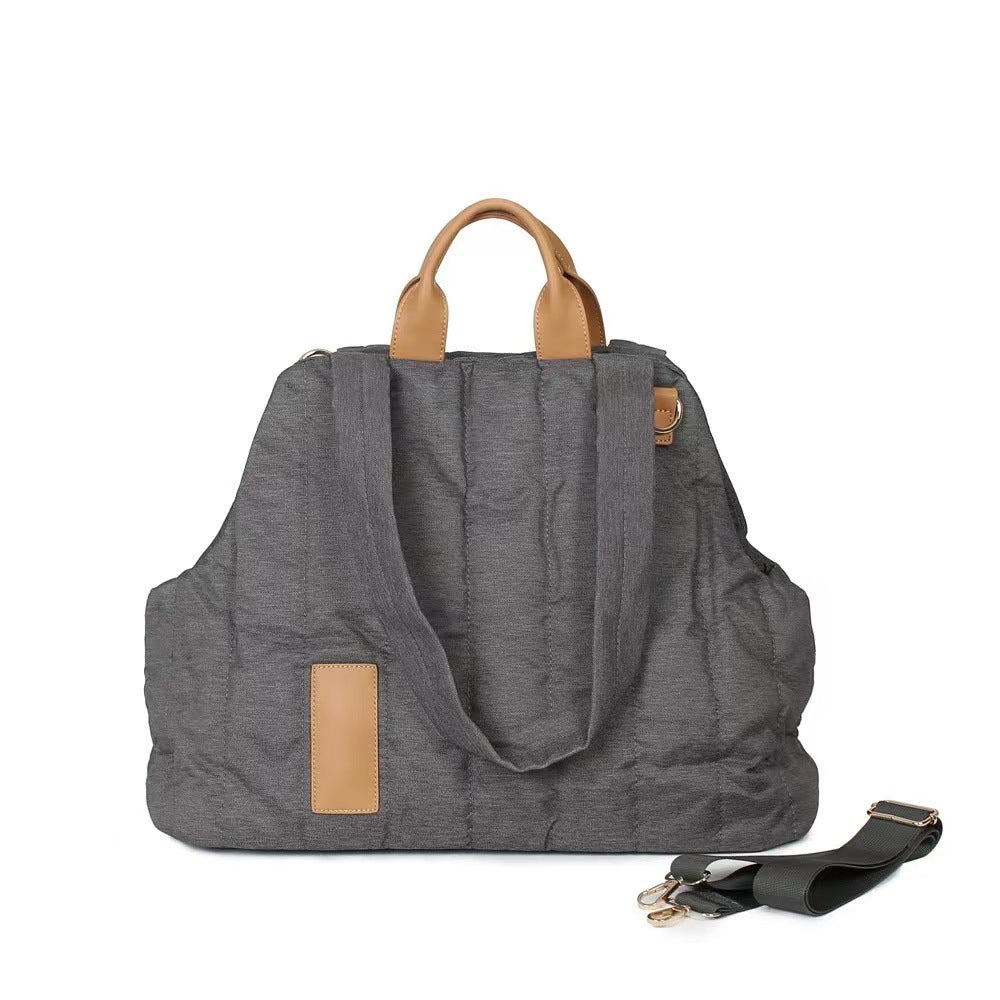 Gray tote bag with brown handles and accents on a white background