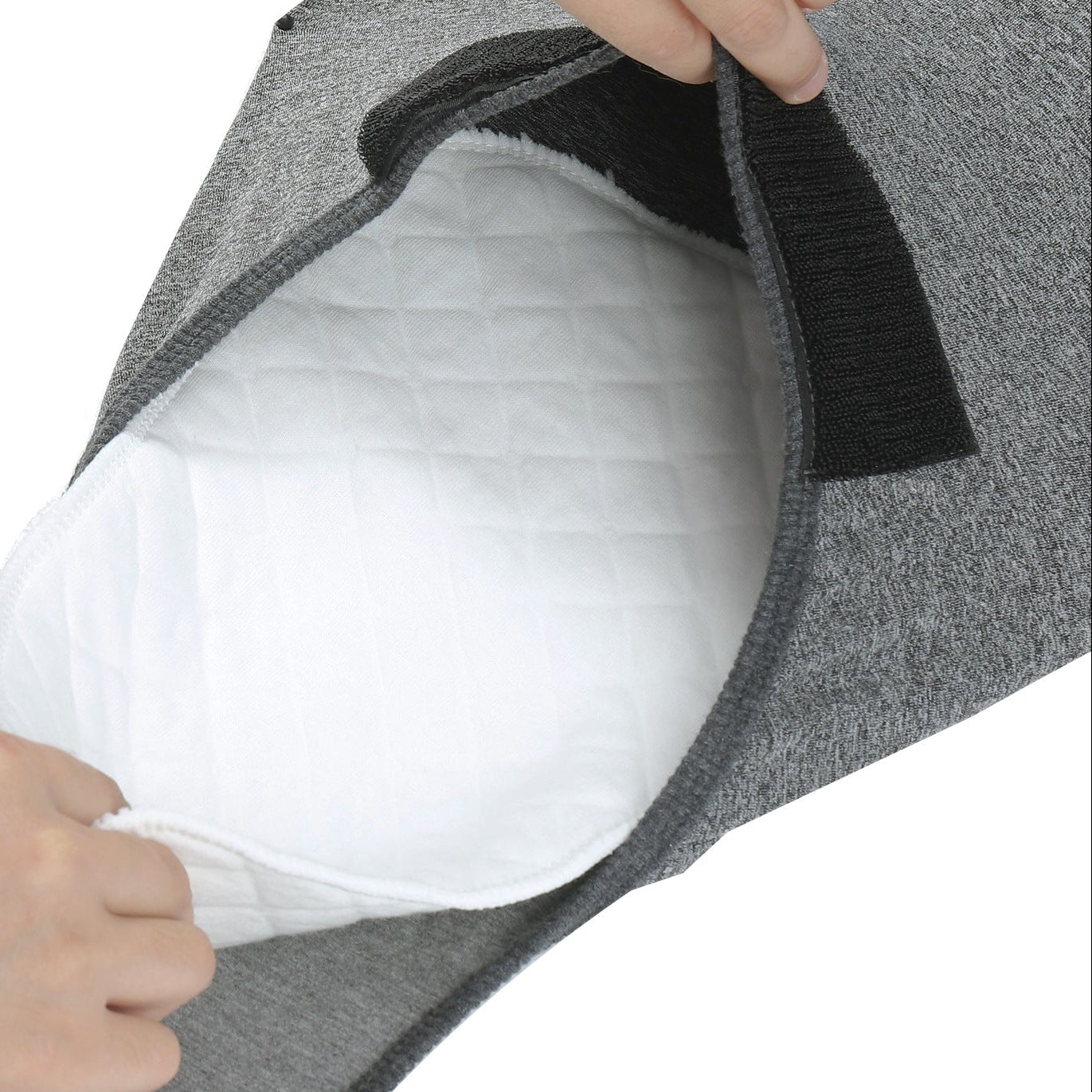 hand insert  a Nappie inside a grey recovery suit