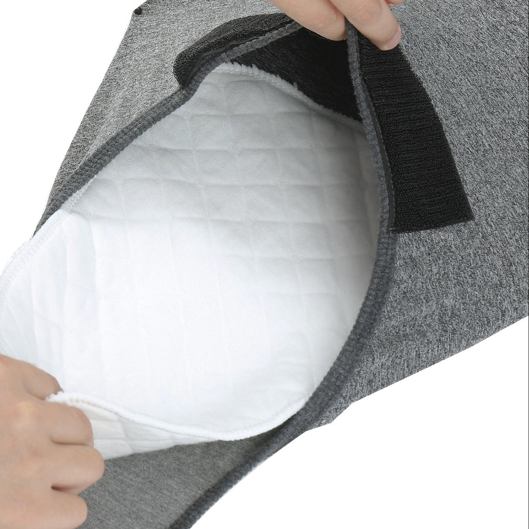 hand insert  a Nappie inside a grey recovery suit