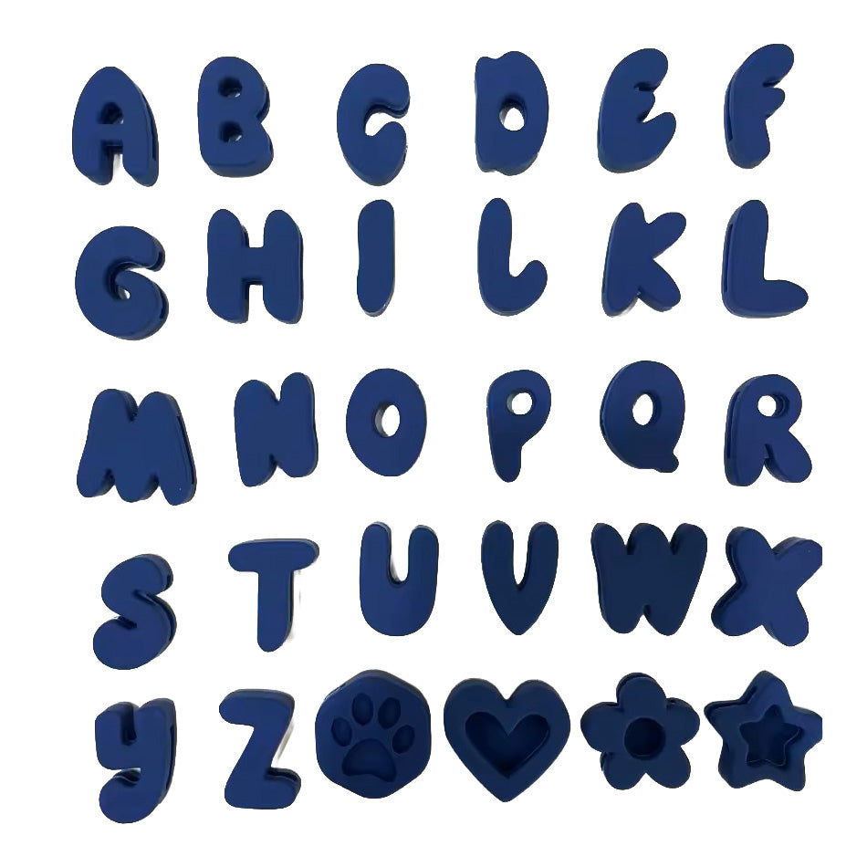 A set of dark blue alphabet letter cutters and icons (including a paw print, heart, and flower) arranged in a grid on a plain white background.