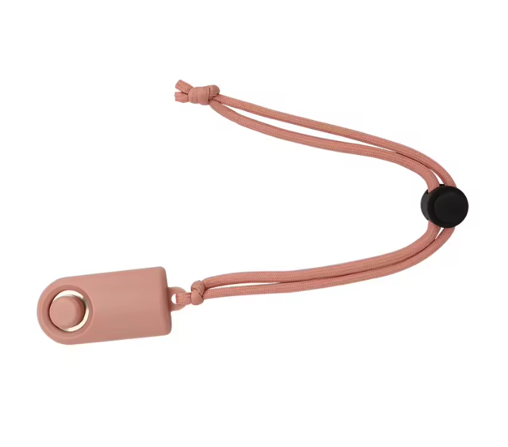 A pink silicone training clicker with a matching pink rectangular tag, a black snap button, and a gold-tone metal ring accent, shown on a plain white background.